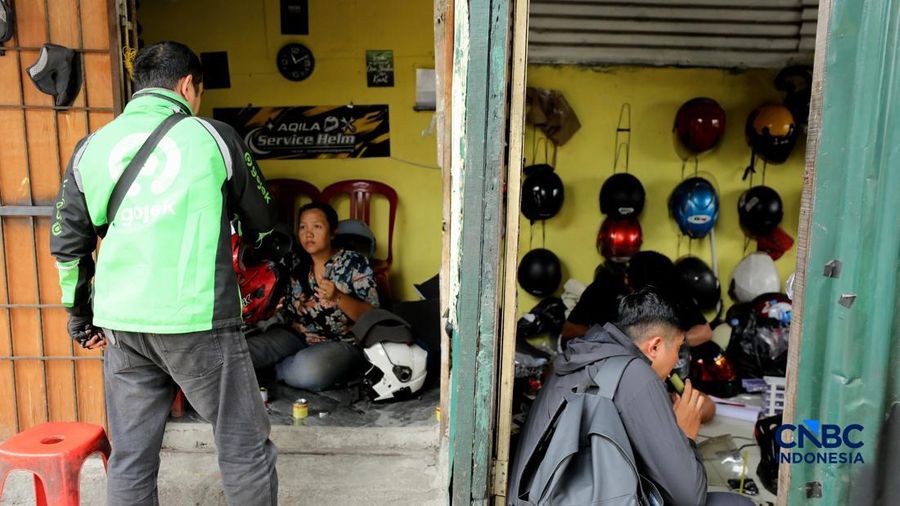 Pekerja melakukan perbaikan helm milik konsumen di salah satu gerai di kawasan Jakarta, Rabu (21/10/2026).