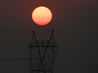 The sun sets next to power lines along San Fernando town, Pampanga province, north of Manila on April 16, 2026. (Photo by Ted ALJIBE / AFP)