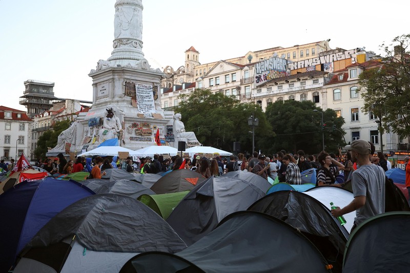 People at a protest camp Rossio square against house crisis and cost of living, in Lisbon, Portugal, October 19, 2026. REUTERS/Pedro Nunes
