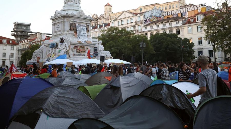 People at a protest camp Rossio square against house crisis and cost of living, in Lisbon, Portugal, October 19, 2026. REUTERS/Pedro Nunes