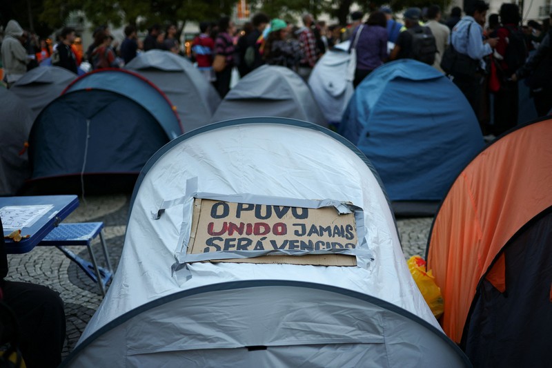 People at a protest camp Rossio square against house crisis and cost of living, in Lisbon, Portugal, October 19, 2026. REUTERS/Pedro Nunes
