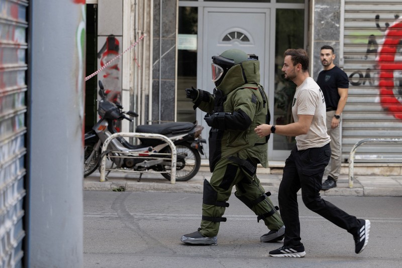 Police tape cordons off the site, following an explosion at a building in central Athens, in which police officers and members of the public were injured, in Athens, Greece, October 21, 2026. REUTERS/Stelios Misinas