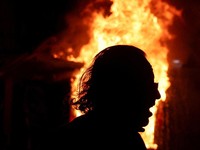 A person walks in front of a fire during an anti-government protest by students in Tirana, Albania, October 24, 2026. REUTERS/Florion Goga     TPX IMAGES OF THE DAY
