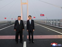 North Korean leader Kim Jong Un and Chinese People's Political Consultative Conference (CPPCC) Chairman Wang Huning pose for a photograph on the New Yalu River Bridge linking Dandong, China, and Sinuiju, North Korea, during Kim's visit to Dandong, Li