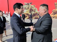North Korean leader Kim Jong Un shakes hands with Chinese People's Political Consultative Conference (CPPCC) Chairman Wang Huning during a visit to the Memorial Hall of the War to Resist US Aggression and Aid Korea, in Dandong, Liaoning province, Chi