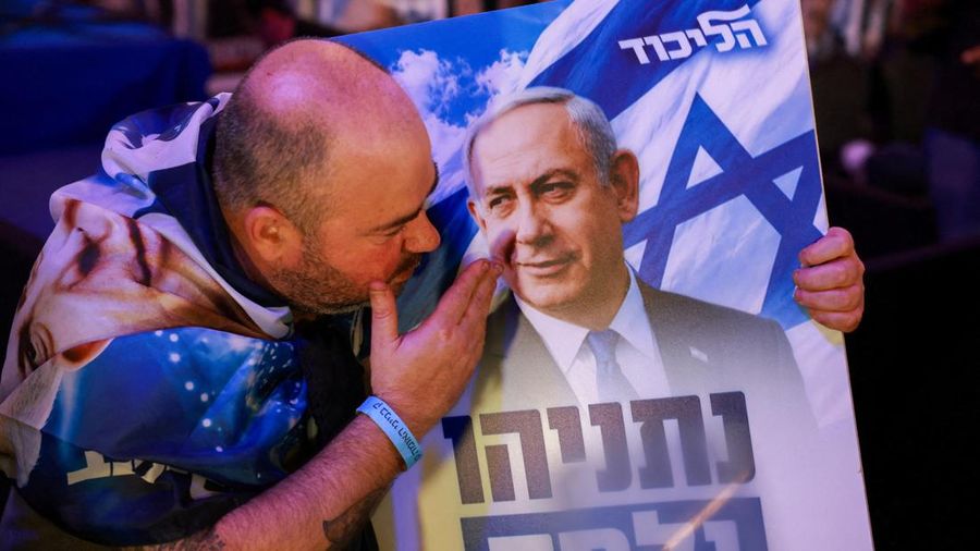 A supporter reacts to exit polls with a sign depicting Israeli Prime Minister and Likud party leader Benjamin Netanyahu during Israel's national election, at Likud's election headquarters in Jerusalem, October 27, 2026. REUTERS/Ronen Zvulun     TPX I
